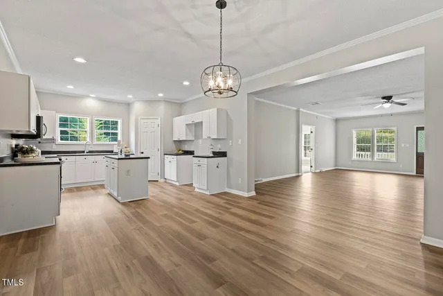 a view of a kitchen with stove and wooden floor