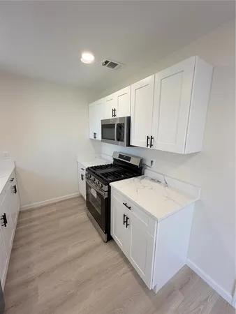 a kitchen with a stove and a microwave