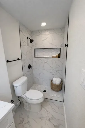a bathroom with a toilet and a shower