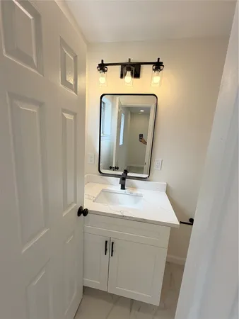 a bathroom with a sink and mirror