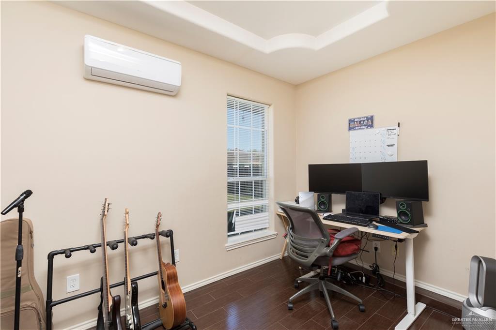 1801 Largo Street Weslaco, TX 78596 - Photo 5 of 20 a workspace with furniture and wooden floor