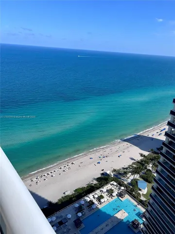 a bathroom with a double vanity sink a mirror and a bathtub