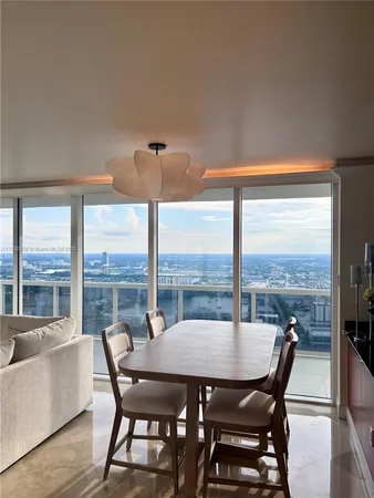 a view of a dining room with furniture and window