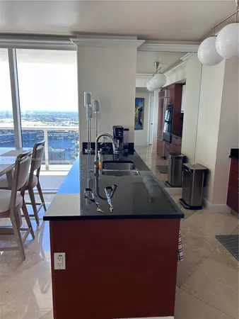 a view of a room with a balcony and ceiling fan