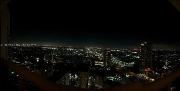 a view of a balcony with chairs and a potted plant