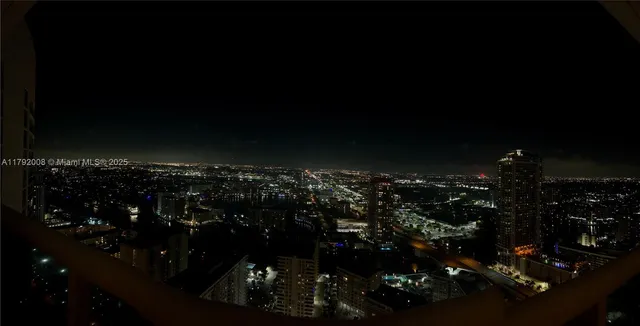 a view of a balcony with chairs and a potted plant