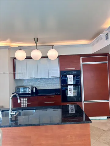 a kitchen with stainless steel appliances granite countertop a stove a cabinets and a sink