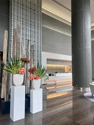 a room with painting on the wall and a table