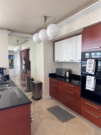 a kitchen with stainless steel appliances granite countertop a sink counter space cabinets and a window