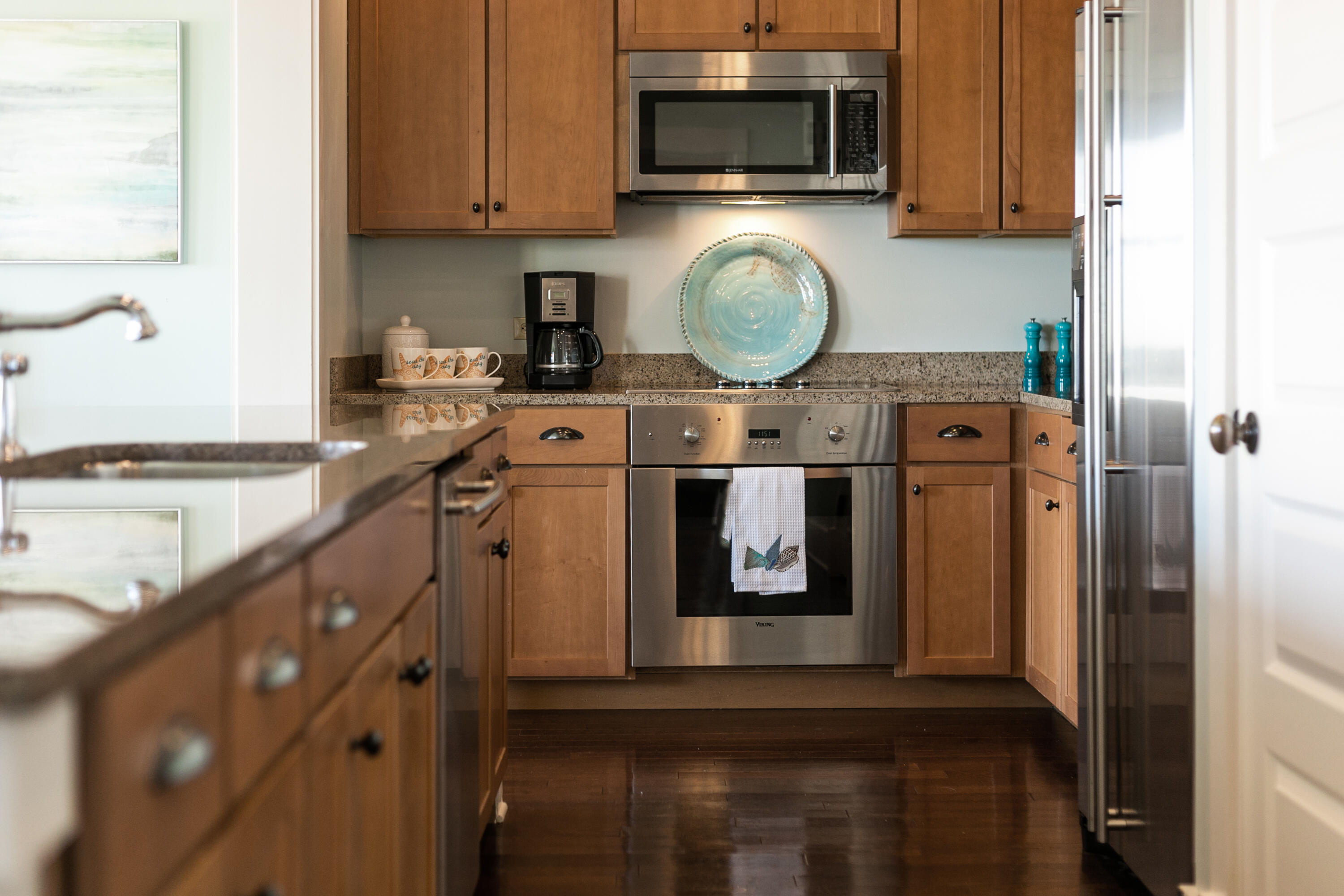 2050 West County Highway 30A, Unit M1314 Santa Rosa Beach, FL 32459 - Photo 11 of 79 a kitchen with stainless steel appliances granite countertop a stove a microwave and a refrigerator