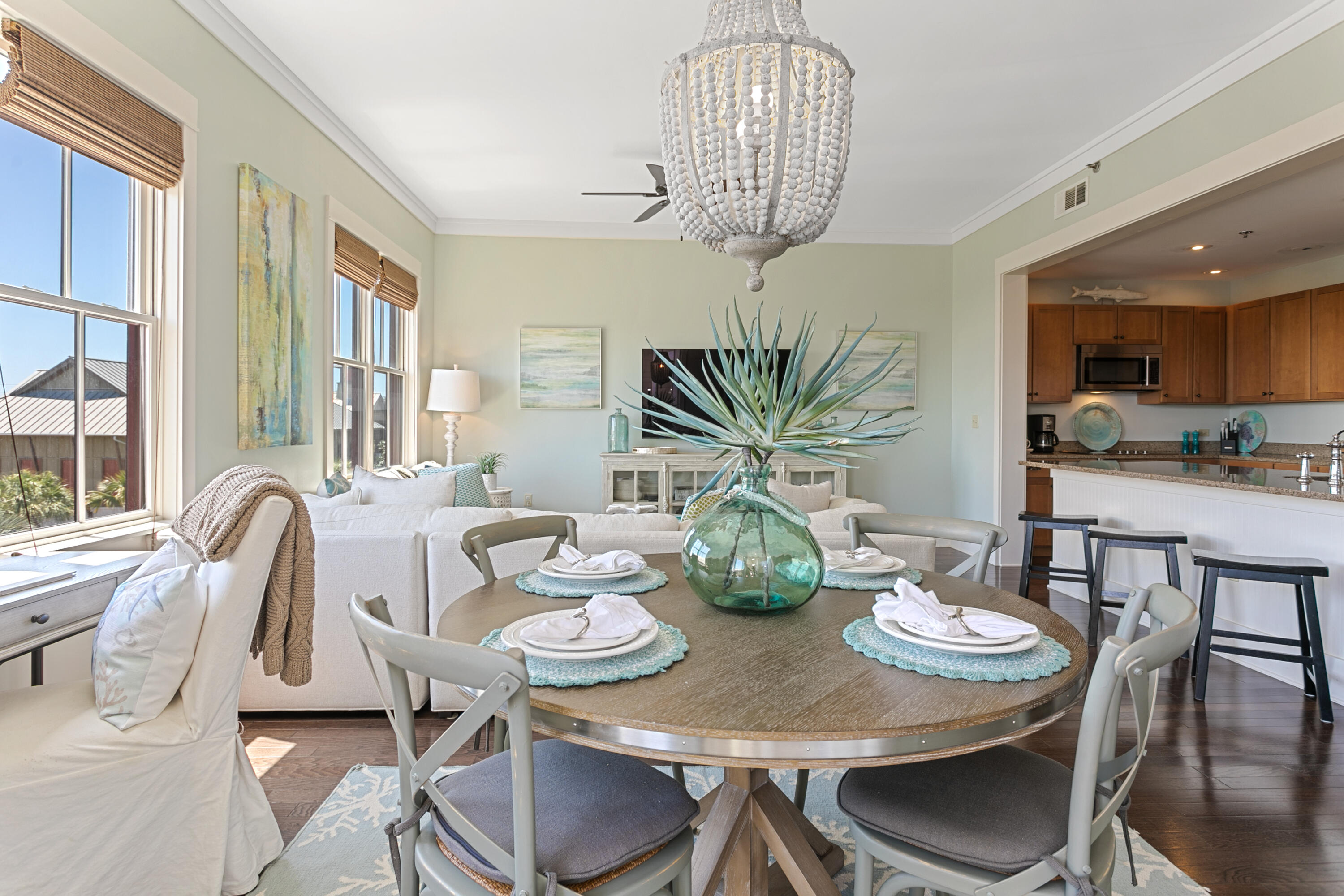 2050 West County Highway 30A, Unit M1314 Santa Rosa Beach, FL 32459 - Photo 25 of 79 a view of a dining room with furniture a chandelier and wooden floor