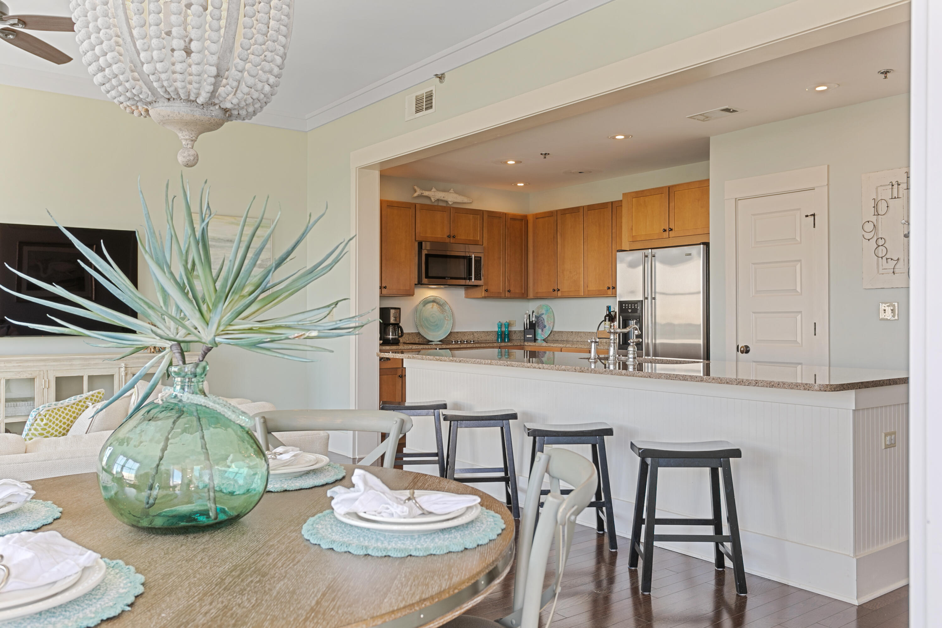 2050 West County Highway 30A, Unit M1314 Santa Rosa Beach, FL 32459 - Photo 27 of 79 a kitchen with stainless steel appliances granite countertop a table and chairs in it