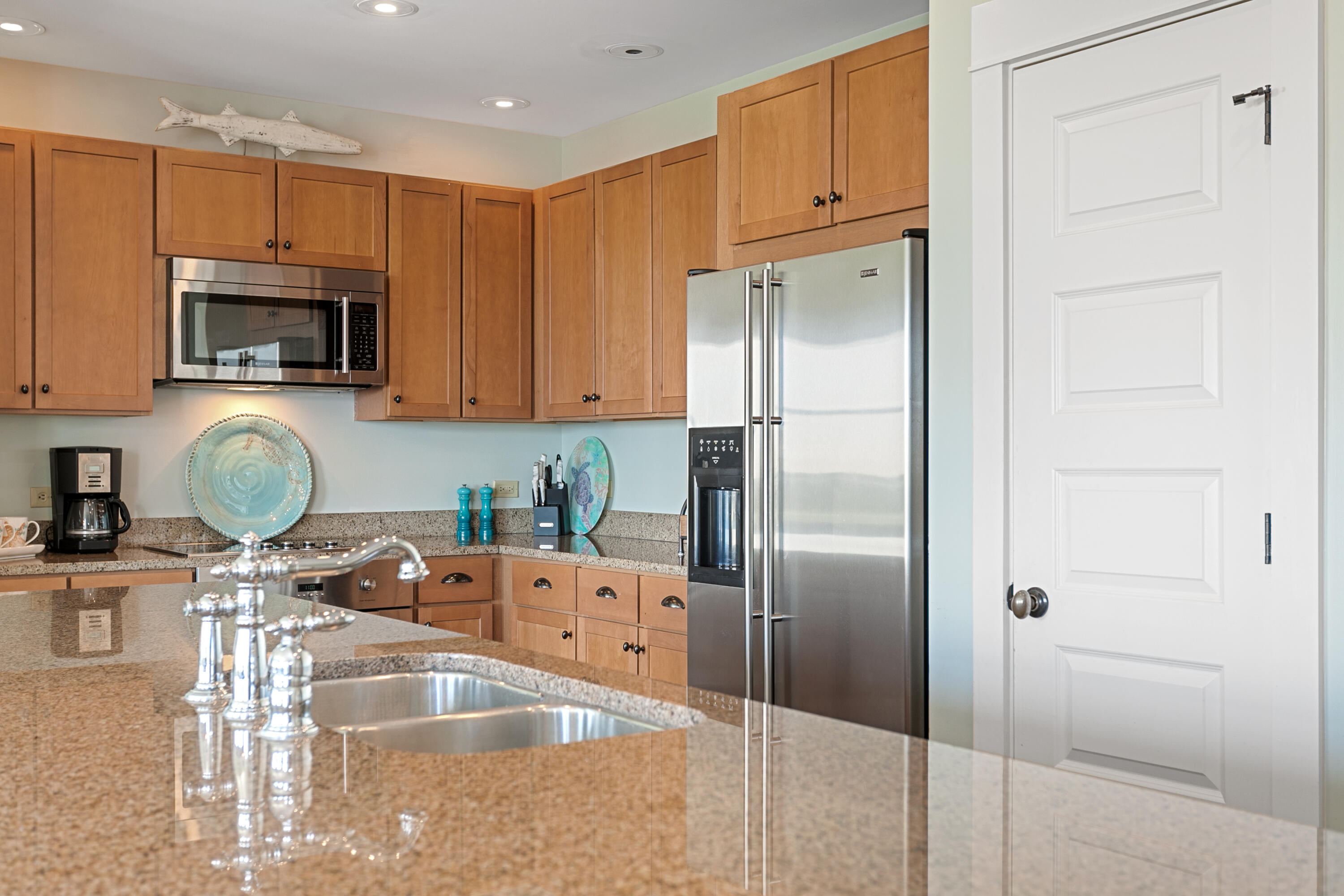 2050 West County Highway 30A, Unit M1314 Santa Rosa Beach, FL 32459 - Photo 8 of 79 a kitchen with stainless steel appliances granite countertop a refrigerator a stove and a sink with wooden cabinets