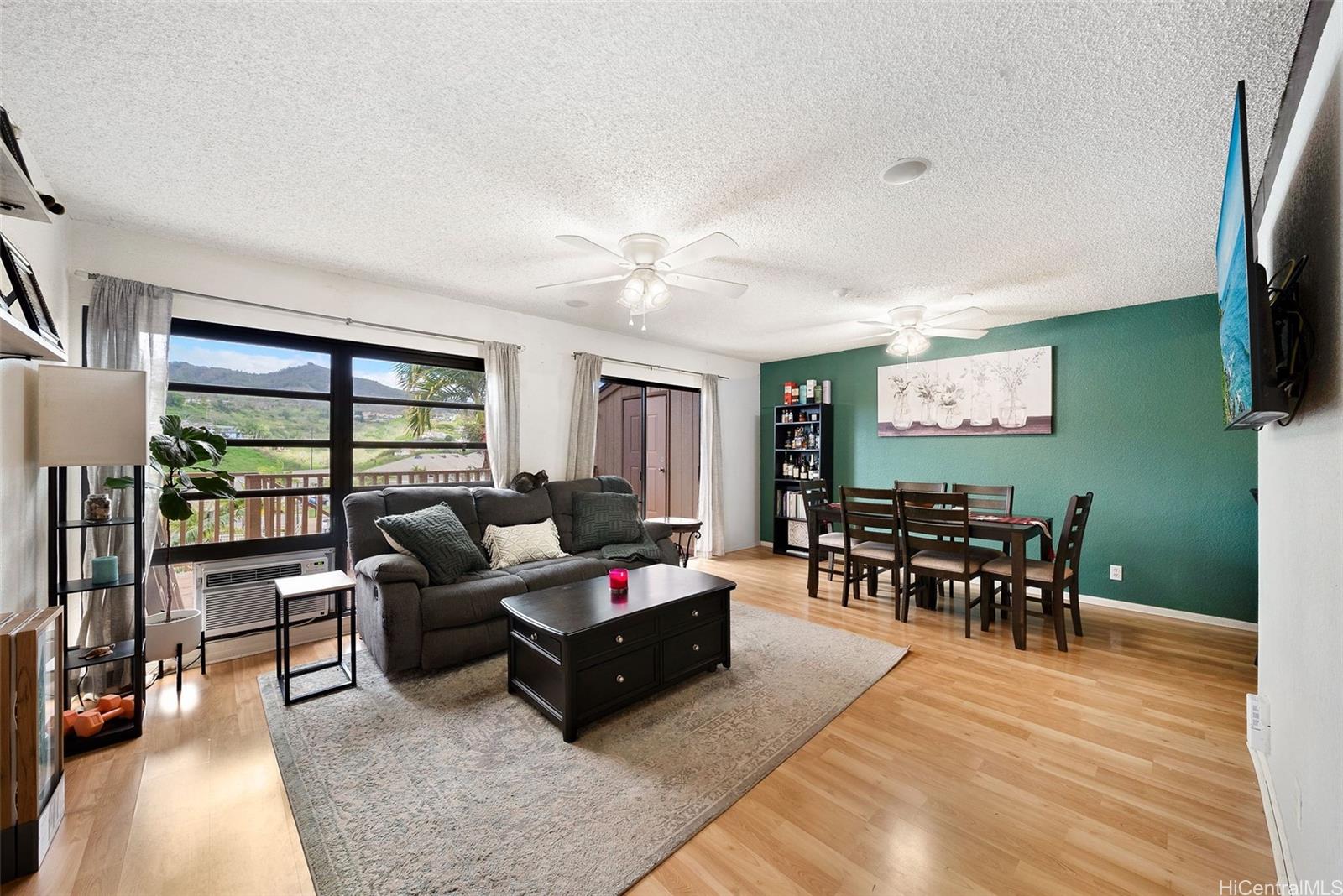 92-1046 Kanehoa Loop, Unit 80 Kapolei, HI 96707 - Photo 1 of 1 a living room with furniture and a flat screen tv