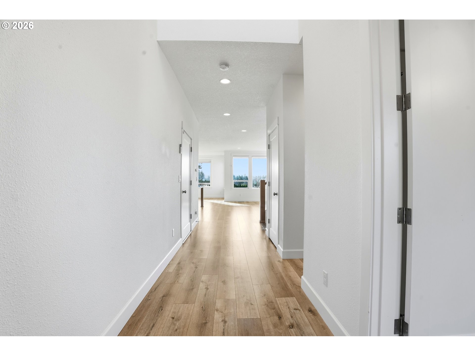 14146 South Cleveland Street Oregon City, OR 97045 - Photo 3 of 46 a view of a hallway with wooden floor