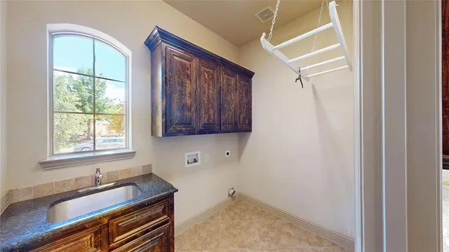 an empty room with windows and ceiling fan