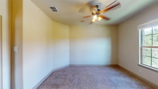 a view of a large house with a big yard and large trees