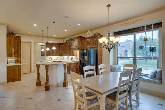 a dining room with furniture and a chandelier