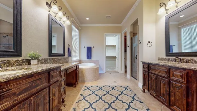 a spacious bathroom with a granite countertop sink and a mirror