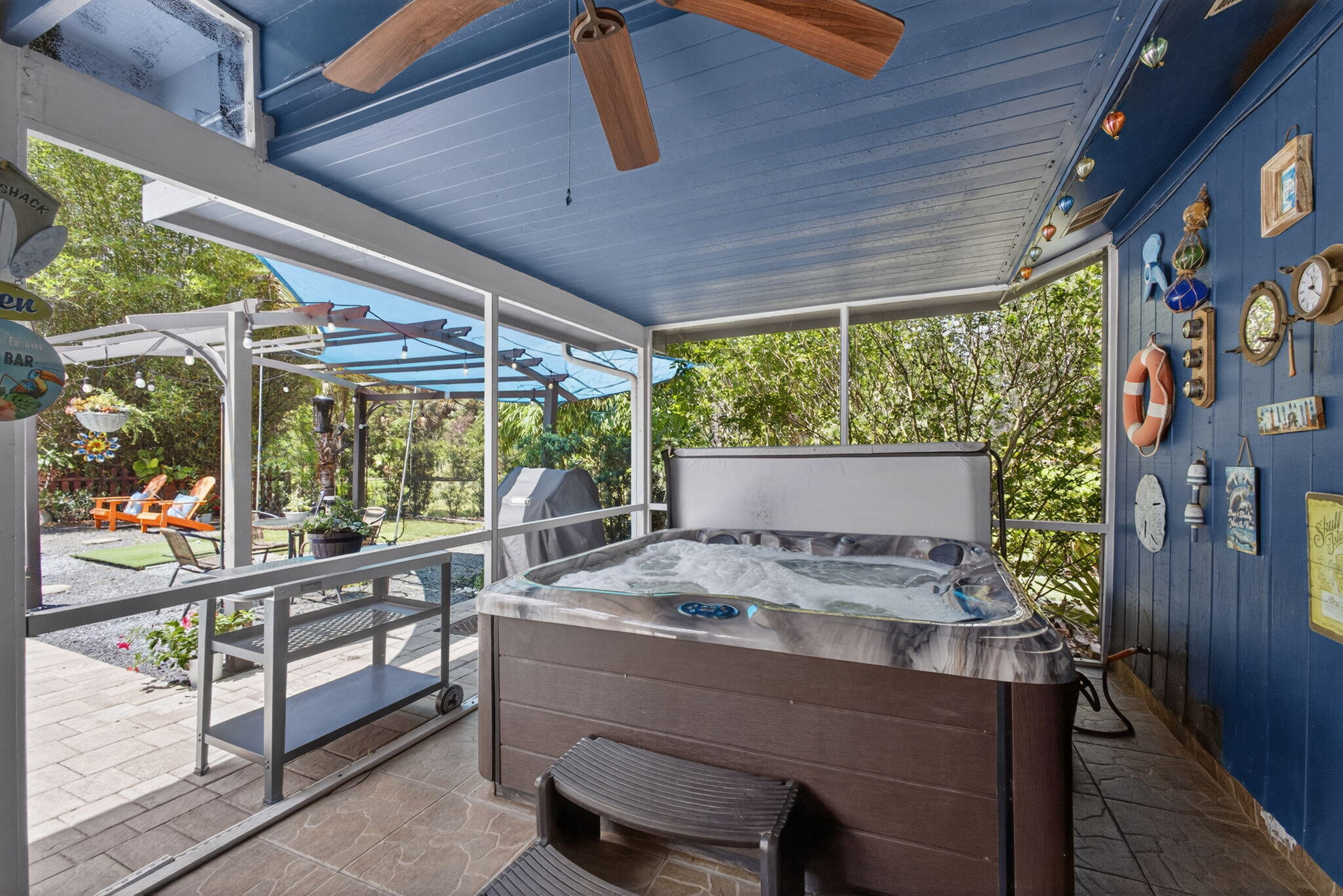 12558 165th Road North Jupiter, FL 33478 - Photo 37 of 67 a outdoor space with the couches and dining table with the garden view