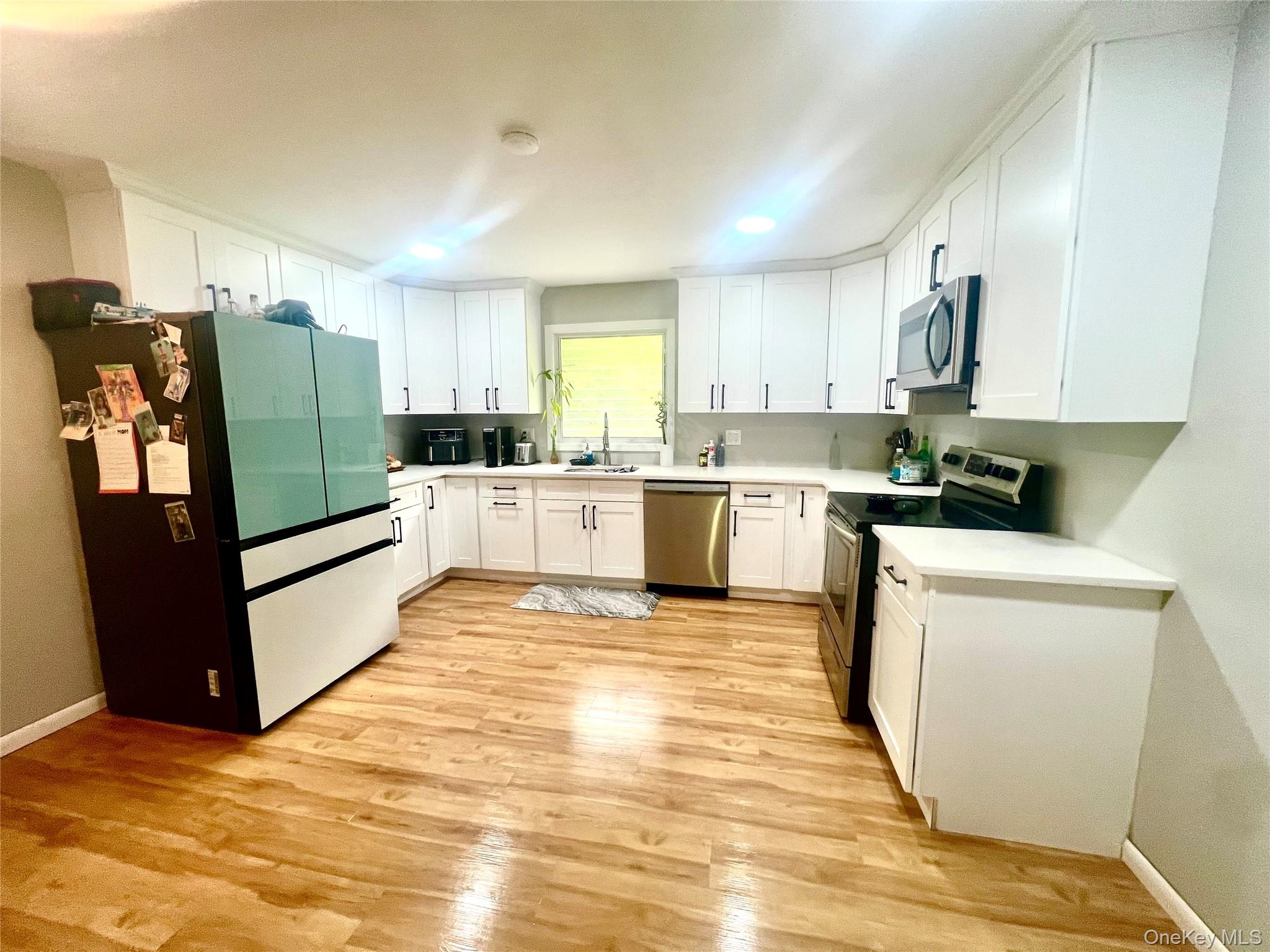 26 Orange Road Florida, NY 10921 - Photo 12 of 39 a kitchen with stainless steel appliances granite countertop a refrigerator sink and white cabinets
