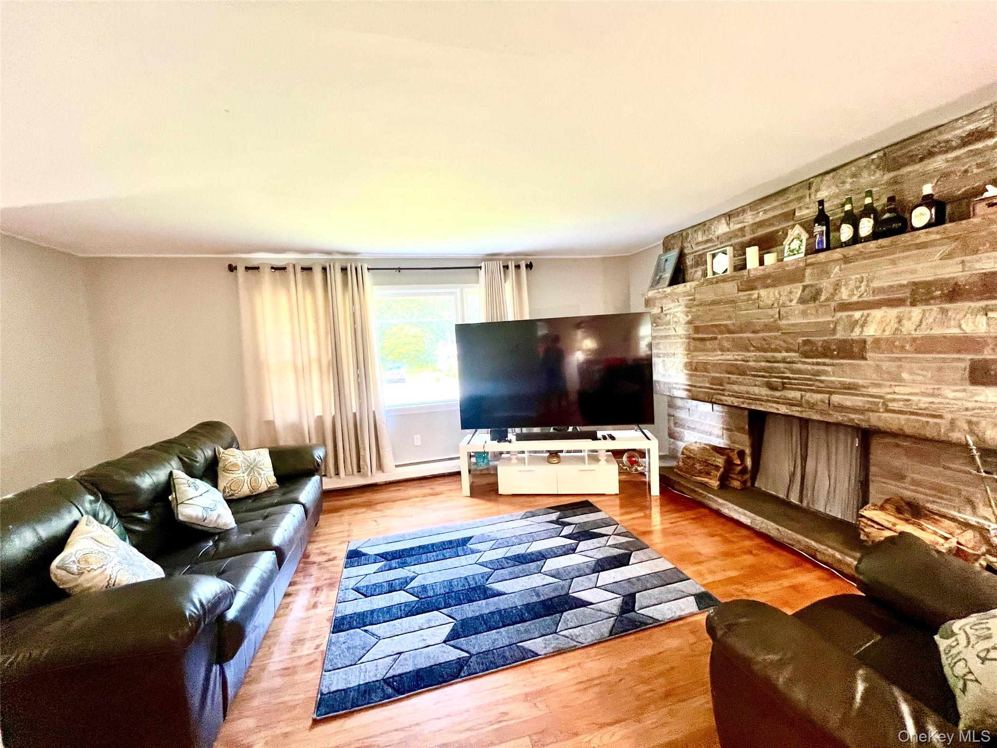 26 Orange Road Florida, NY 10921 - Photo 7 of 39 a living room with furniture and a flat screen tv
