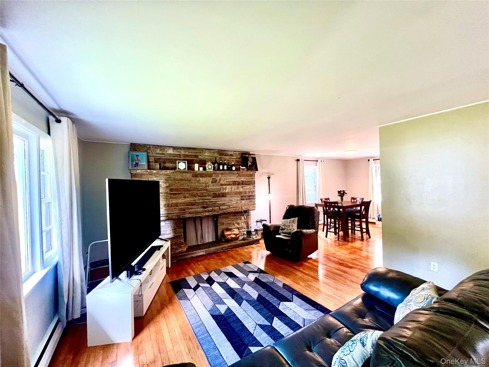 26 Orange Road Florida, NY 10921 - Photo 9 of 39 a living room with furniture a fireplace and a flat screen tv
