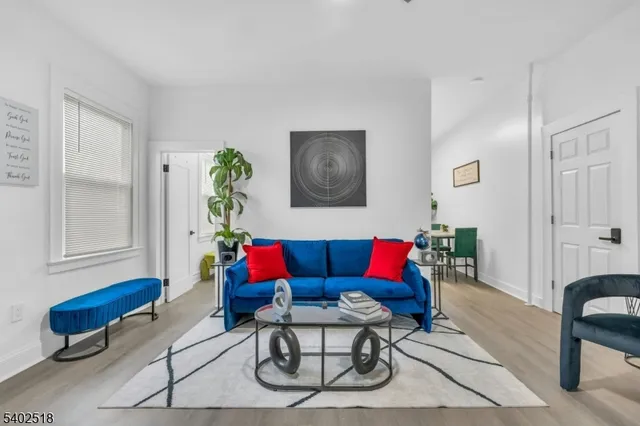 a living room with furniture a rug and a window