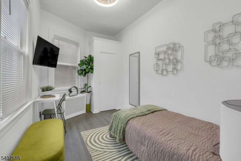 68 Pine Street Montclair, NJ 07042 - Photo 11 of 23 a bedroom with a bed and a flat screen tv