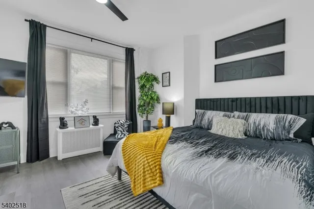 a bedroom with a bed and a large window