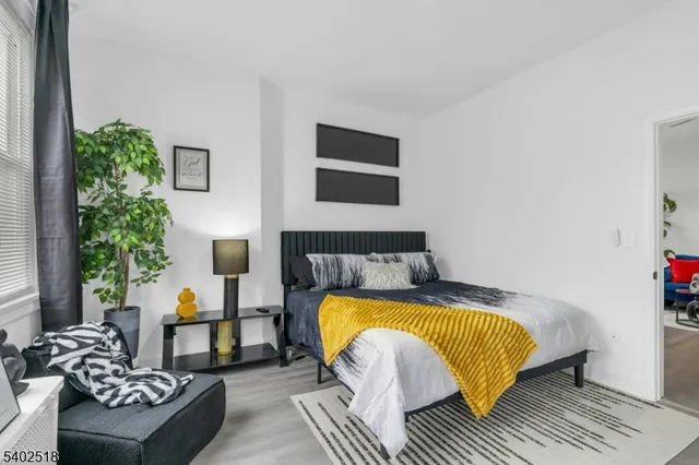 a bedroom with a bed and a couch