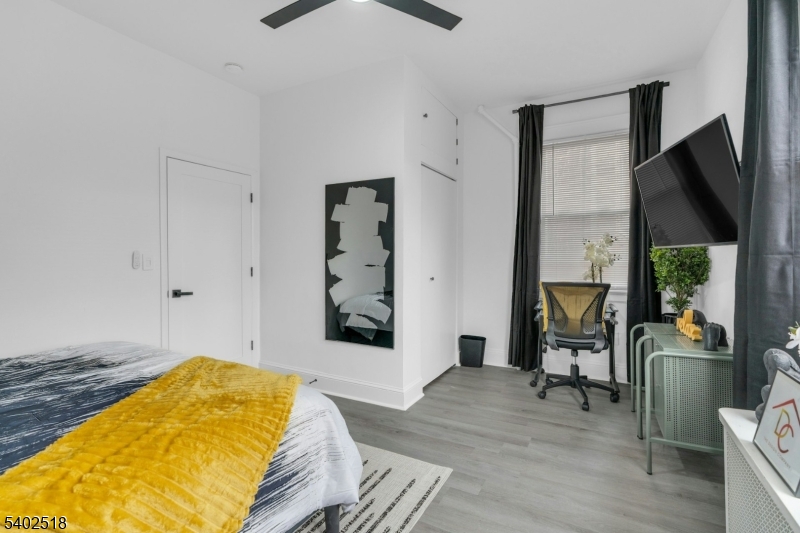 68 Pine Street Montclair, NJ 07042 - Photo 15 of 23 a bedroom with a bed and wooden floor