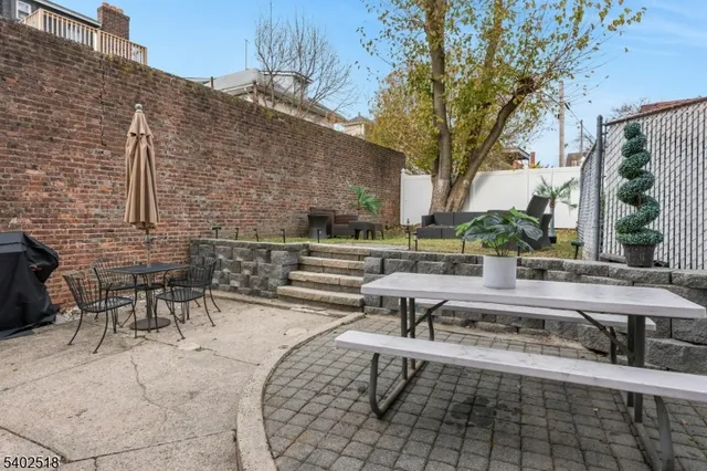 a view of a patio with table and chairs and potted plants