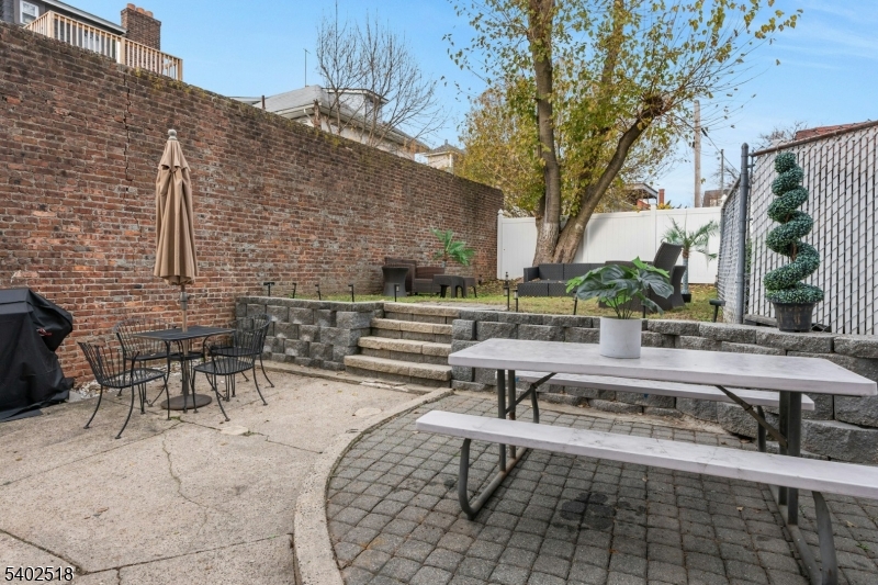 68 Pine Street Montclair, NJ 07042 - Photo 19 of 23 a view of a patio with table and chairs and potted plants