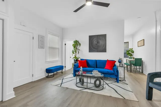 a living room with furniture and wooden floor