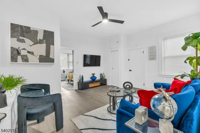 a living room with furniture and wooden floor
