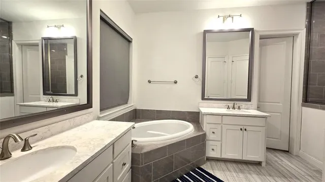 a bathroom with a shower sink and mirror