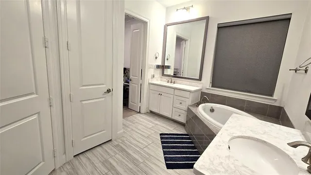 a view of walk in closet with clothes