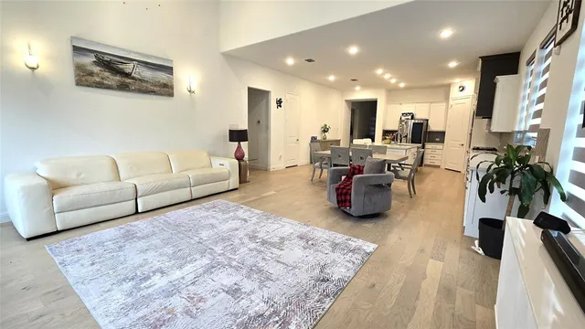 a kitchen with a table chairs refrigerator and cabinets