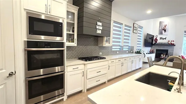 a large kitchen with a lot of counter space and a sink