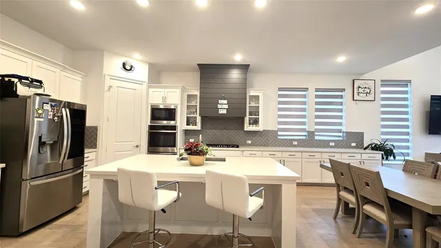 a kitchen that has a sink and a stove in it