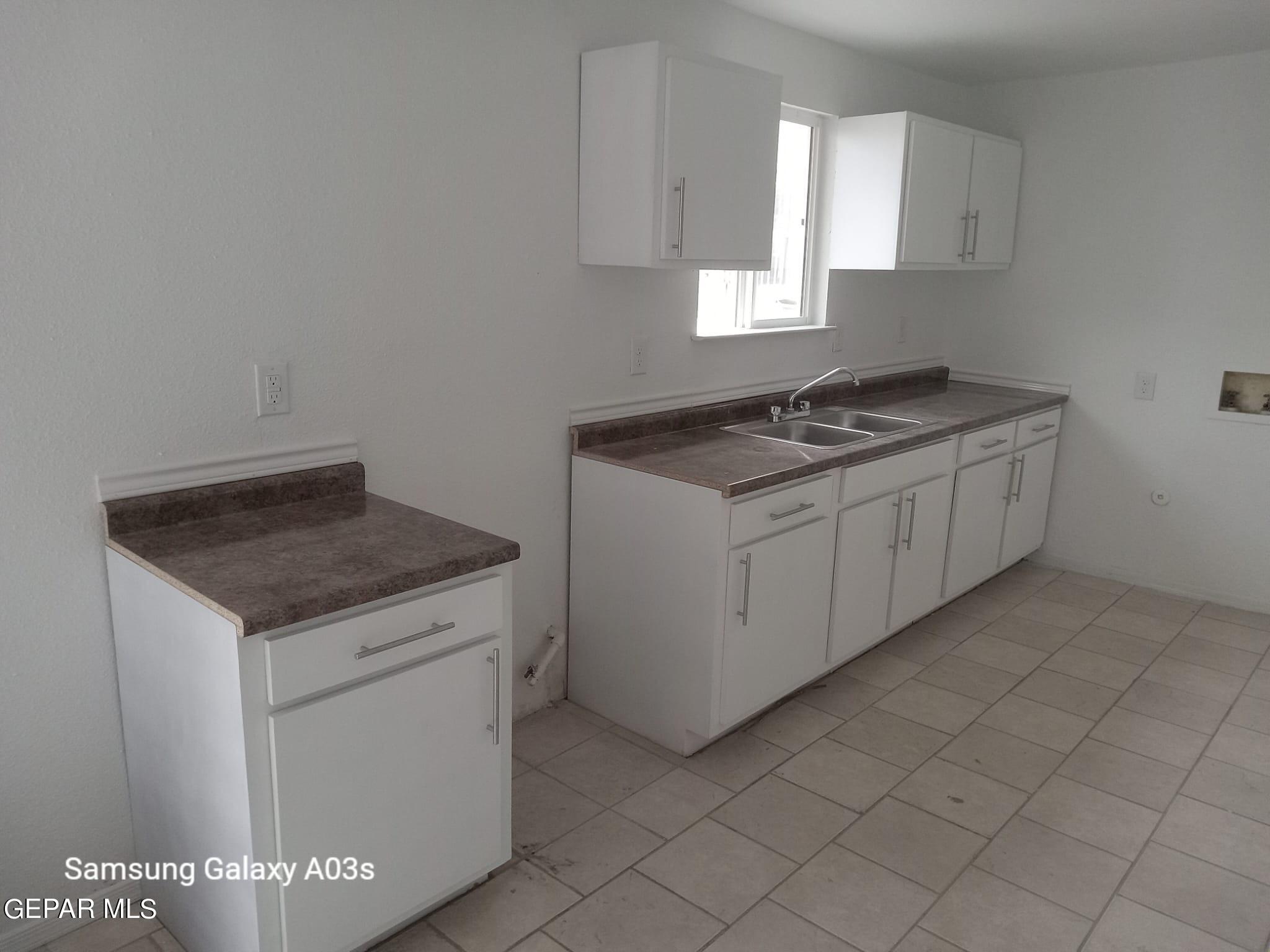 324 Valley Fair Way El Paso, TX 79907 - Photo 19 of 82 a kitchen with granite countertop white cabinets and white appliances