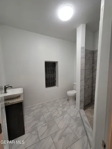 a bathroom with a toilet a sink and bathtub