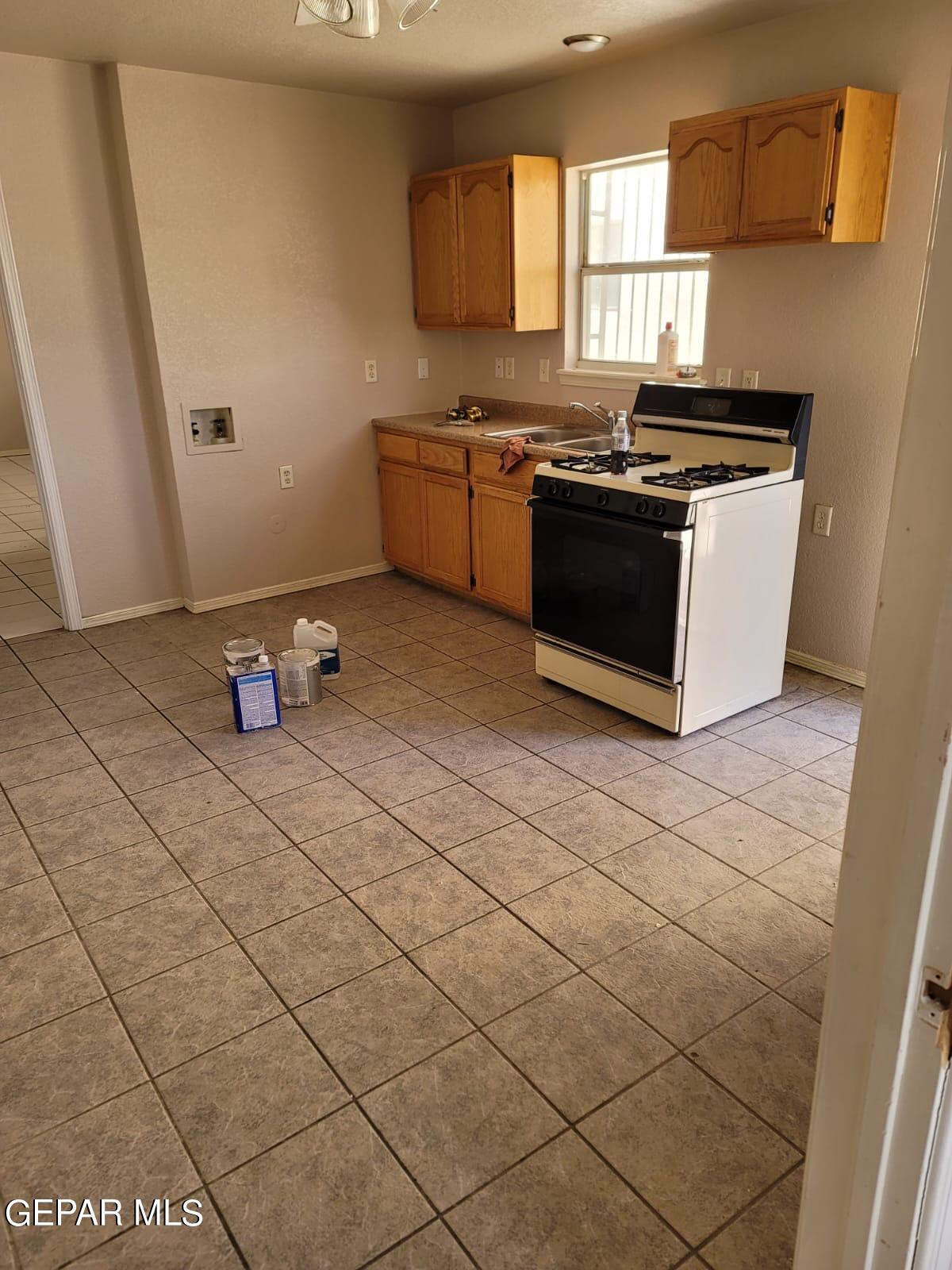 324 Valley Fair Way El Paso, TX 79907 - Photo 43 of 82 a kitchen with stainless steel appliances a stove a sink and a microwave