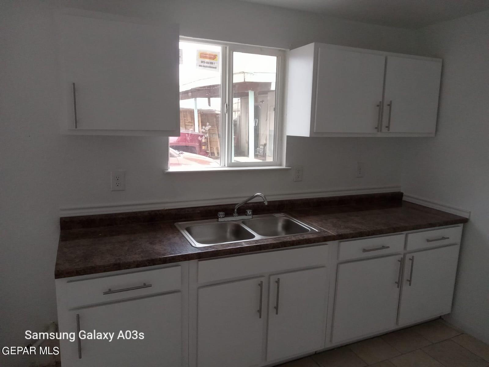 324 Valley Fair Way El Paso, TX 79907 - Photo 50 of 82 a kitchen with granite countertop white cabinets and a sink