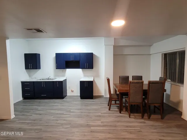 a large kitchen with stainless steel appliances wooden floors and wooden cabinets