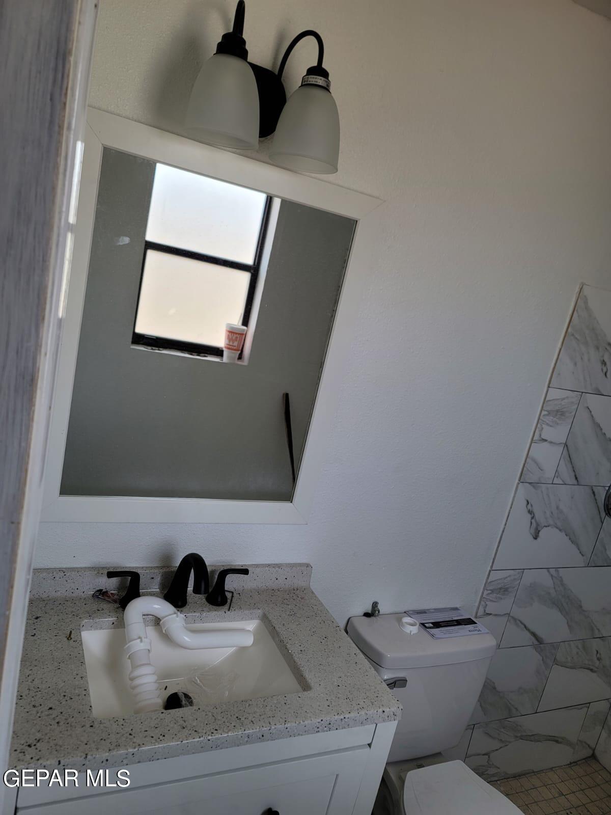 324 Valley Fair Way El Paso, TX 79907 - Photo 52 of 82 a bathroom with a sink toilet and mirror
