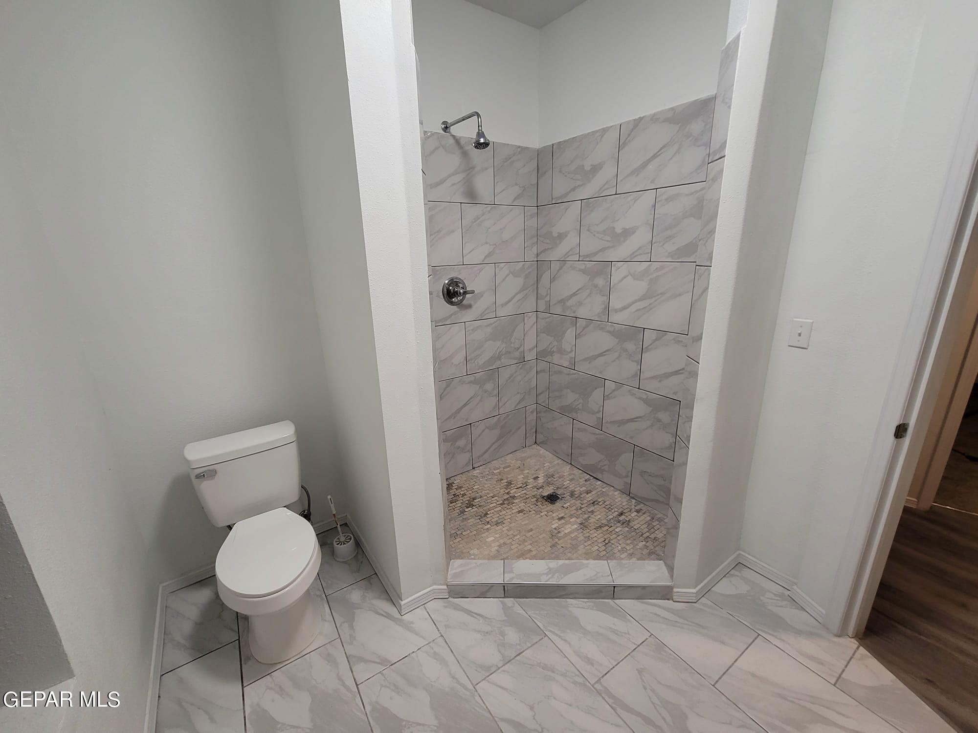 324 Valley Fair Way El Paso, TX 79907 - Photo 64 of 82 a bathroom with a toilet and a shower