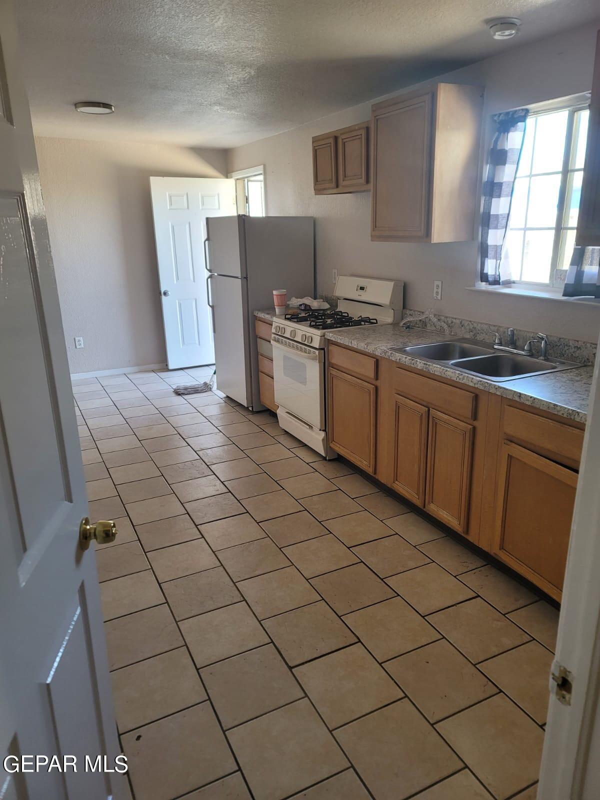 324 Valley Fair Way El Paso, TX 79907 - Photo 9 of 82 a kitchen with stainless steel appliances a sink and a refrigerator