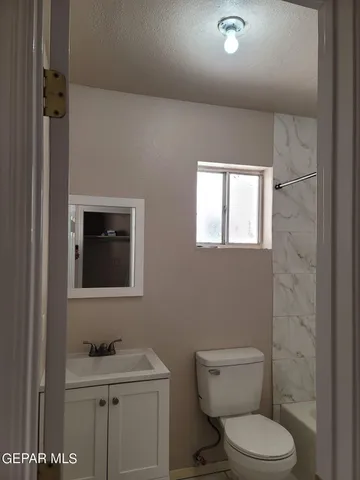 a view of a small space with wooden floor and a chandelier fan